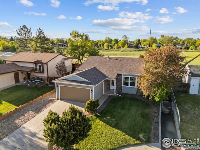 1512 Calkins Ave, Longmont, CO 80501 - view of front of property with a garage, concrete driveway, a shingled roof, and a residential view
