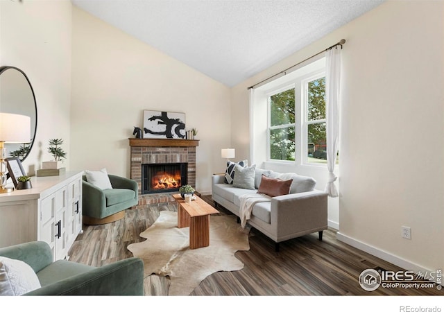 1512 Calkins Ave, Longmont, CO 80501 - living area with wood finished floors, a brick fireplace, lofted ceiling, and baseboards