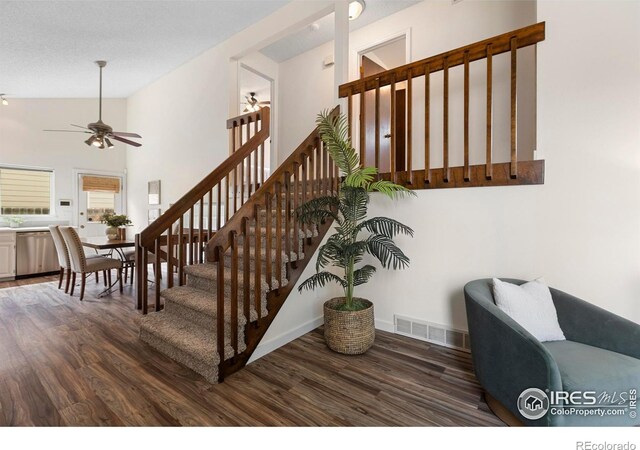 1512 Calkins Ave, Longmont, CO 80501 - stairs featuring wood finished floors, ceiling fan, baseboards, and lofted ceiling