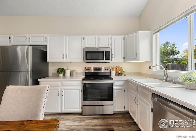 1512 Calkins Ave, Longmont, CO 80501 - kitchen with stainless steel appliances, a sink, white cabinetry, and light countertops