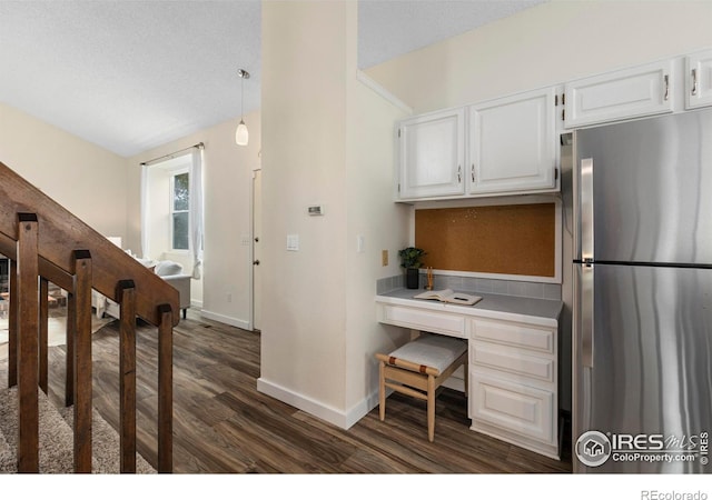 1512 Calkins Ave, Longmont, CO 80501 - kitchen with freestanding refrigerator, dark wood finished floors, baseboards, white cabinetry, and light countertops