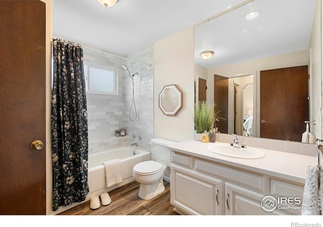 1512 Calkins Ave, Longmont, CO 80501 - full bath with shower / bath combo with shower curtain, toilet, vanity, and wood finished floors