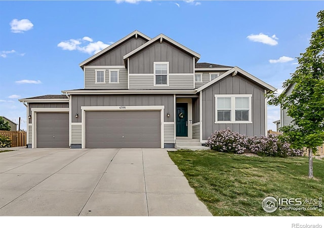6398 Verna Ct, Timnath, CO 80547 - view of front of house with board and batten siding, driveway, an attached garage, and a garage
