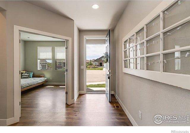 6398 Verna Ct, Timnath, CO 80547 - doorway featuring dark wood-type flooring, recessed lighting, and baseboards
