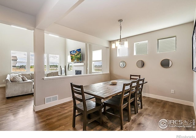 6398 Verna Ct, Timnath, CO 80547 - dining area featuring plenty of natural light, baseboards, and dark wood finished floors