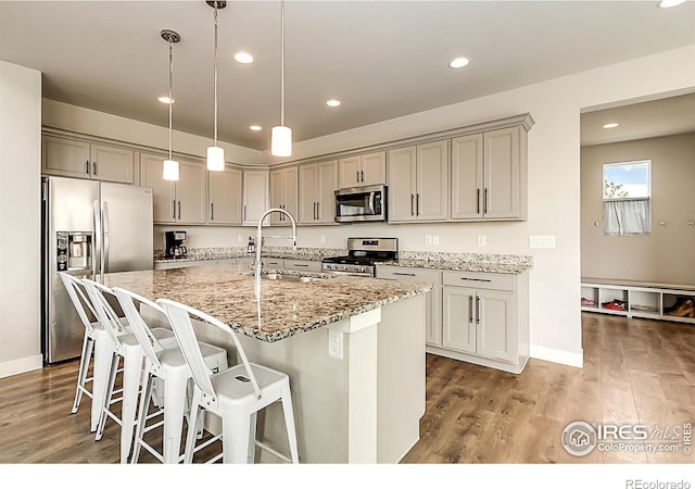 6398 Verna Ct, Timnath, CO 80547 - kitchen with stainless steel appliances, a sink, gray cabinets, light stone counters, and recessed lighting