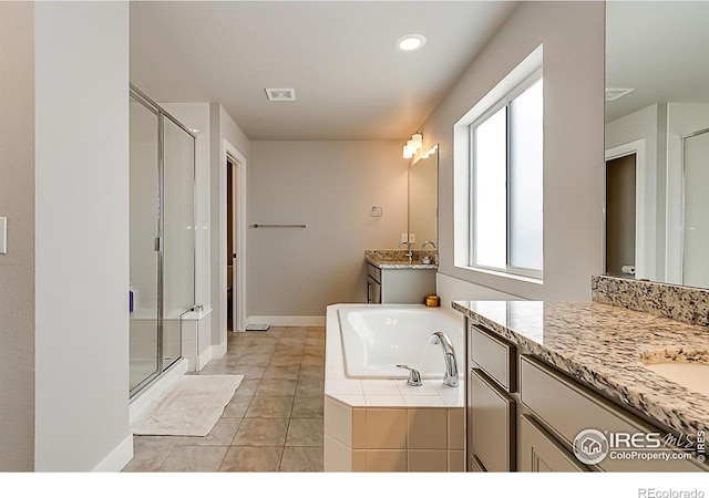 6398 Verna Ct, Timnath, CO 80547 - full bath with a stall shower, two vanities, a garden tub, tile patterned floors, and baseboards