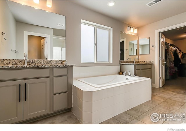 6398 Verna Ct, Timnath, CO 80547 - full bath with two vanities, a garden tub, a spacious closet, and tile patterned floors