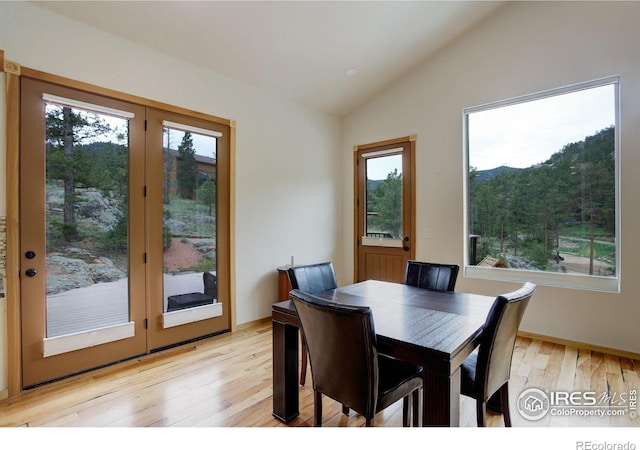 178 Cree Ct, Lyons, CO 80540 - dining room with lofted ceiling, plenty of natural light, and light wood finished floors