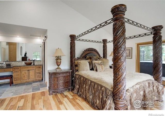 178 Cree Ct, Lyons, CO 80540 - bedroom featuring light wood finished floors, multiple windows, and high vaulted ceiling