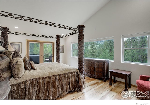 178 Cree Ct, Lyons, CO 80540 - bedroom featuring access to outside, light wood-type flooring, high vaulted ceiling, multiple windows, and recessed lighting