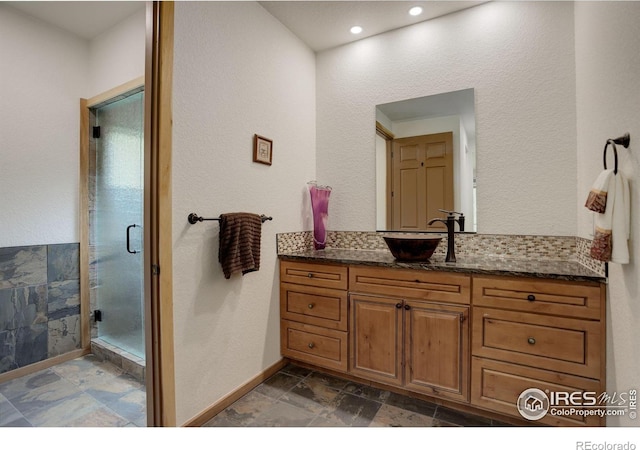 178 Cree Ct, Lyons, CO 80540 - full bath with vanity, a stall shower, stone finish flooring, baseboards, and recessed lighting