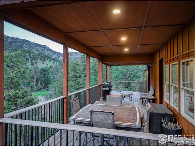 178 Cree Ct, Lyons, CO 80540 - wooden deck featuring outdoor dining space, grilling area, a mountain view, and a forest view