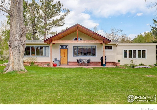 9445 Lykins Pl, Boulder, CO 80301 - view of front of home with a front yard and a patio area
