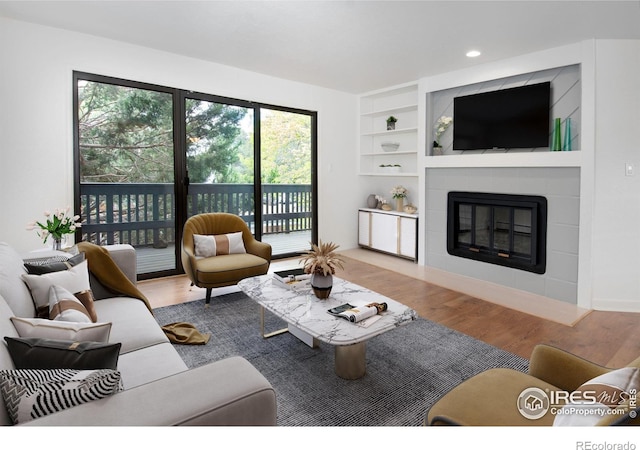 3275 34th St Unit 76, Boulder, CO 80301 - living area with wood finished floors, a fireplace, healthy amount of natural light, built in features, and recessed lighting