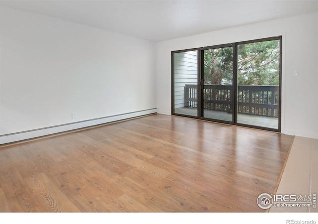3275 34th St Unit 76, Boulder, CO 80301 - unfurnished room with a baseboard heating unit and wood finished floors