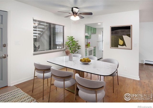 3275 34th St Unit 76, Boulder, CO 80301 - dining space featuring wood finished floors, ceiling fan, a baseboard heating unit, and baseboards