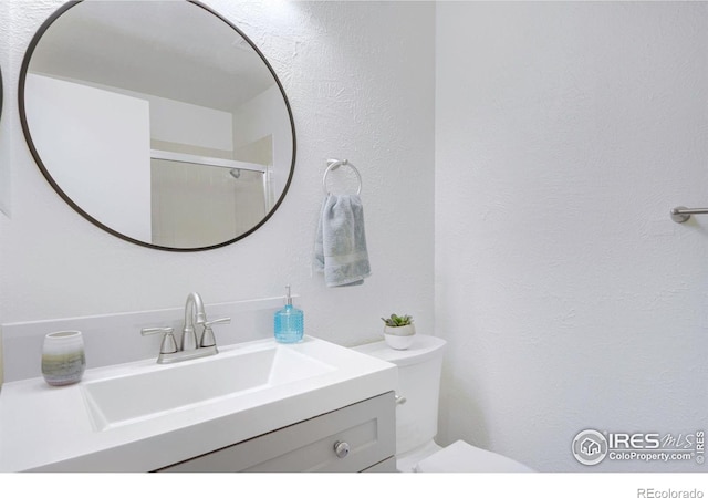 3275 34th St Unit 76, Boulder, CO 80301 - full bath with toilet, vanity, a shower with shower door, and a textured wall
