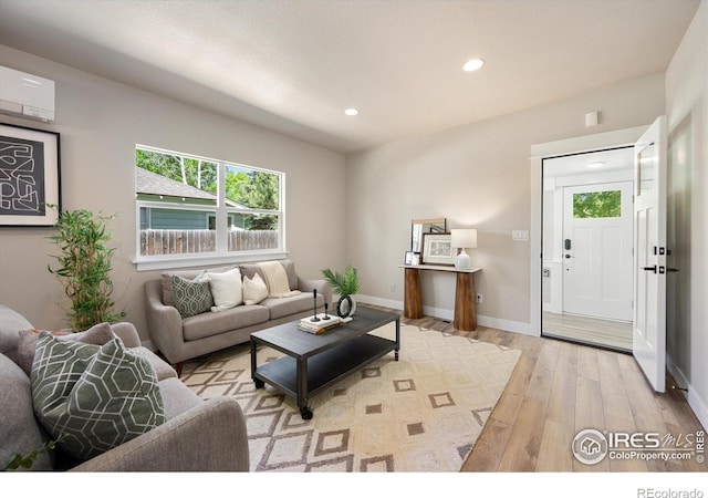 217 Locust St, Windsor, CO 80550 - living room with hardwood / wood-style flooring, recessed lighting, baseboards, and an AC wall unit