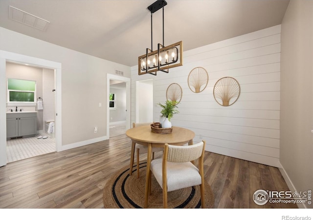 217 Locust St, Windsor, CO 80550 - dining space featuring wood finished floors, a chandelier, and baseboards