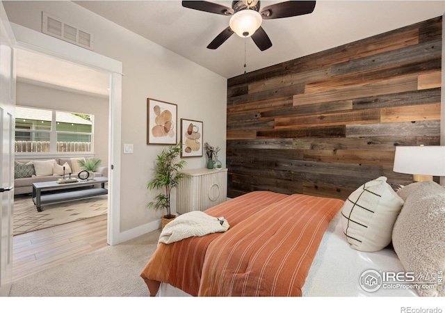 217 Locust St, Windsor, CO 80550 - bedroom featuring wooden walls, wood finished floors, a ceiling fan, and baseboards