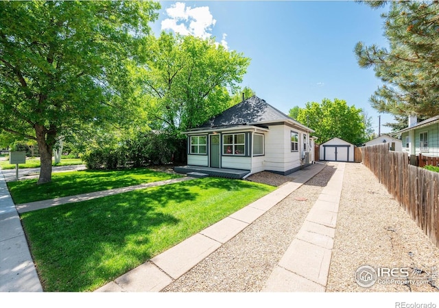 217 Locust St, Windsor, CO 80550 - view of front of property featuring a detached garage, driveway, and a shingled roof