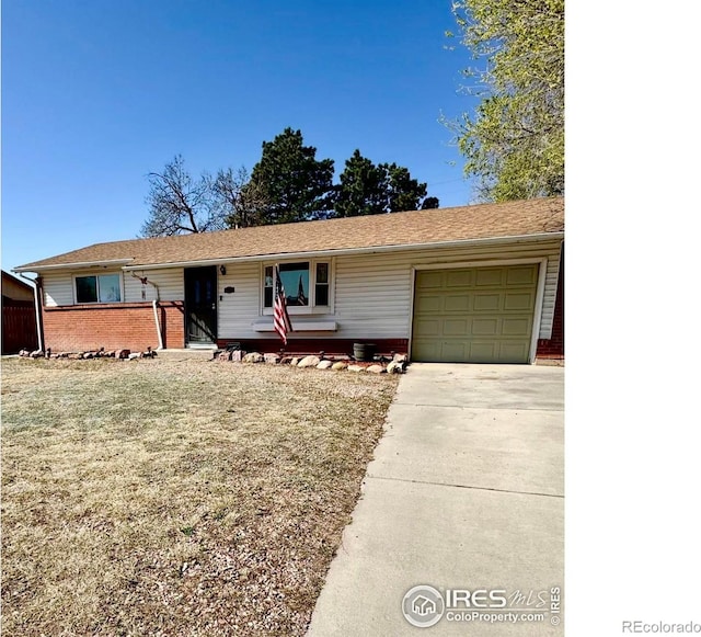 2614 Willard Dr, Colorado Springs, CO 80911 - ranch-style house with an attached garage, concrete driveway, and brick siding