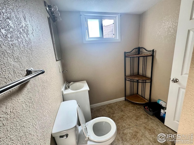2614 Willard Dr, Colorado Springs, CO 80911 - bathroom with toilet, tile patterned floors, and a sink