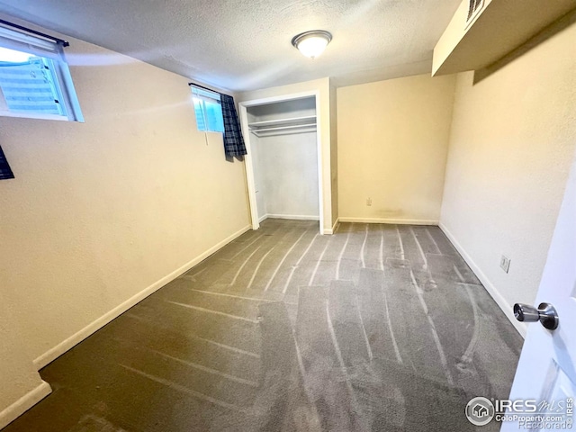 2614 Willard Dr, Colorado Springs, CO 80911 - unfurnished bedroom featuring a textured ceiling, carpet flooring, baseboards, and a closet