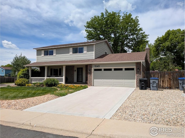 1545 S Vivian St, Longmont, CO 80501 - traditional-style home featuring a garage, a porch, concrete driveway, brick siding, and a chimney
