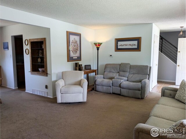 1545 S Vivian St, Longmont, CO 80501 - carpeted living area with stairway, a textured ceiling, and baseboards