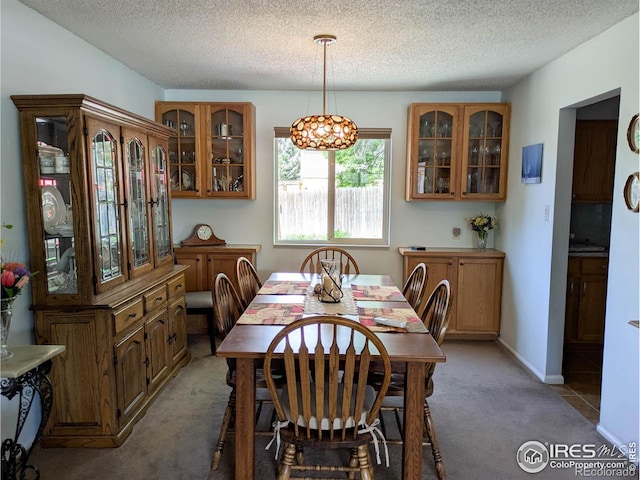 1545 S Vivian St, Longmont, CO 80501 - dining room with light carpet, a textured ceiling, and a chandelier
