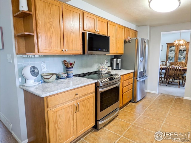 1545 S Vivian St, Longmont, CO 80501 - kitchen with stainless steel appliances, open shelves, backsplash, baseboards, and light tile patterned floors