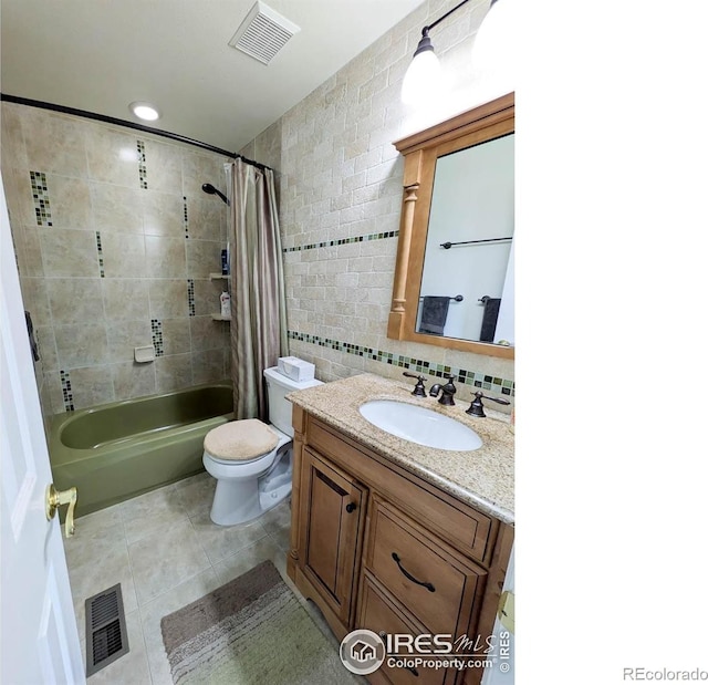 1545 S Vivian St, Longmont, CO 80501 - bathroom featuring tile walls, tile patterned flooring, vanity, shower / bathtub combination with curtain, and toilet