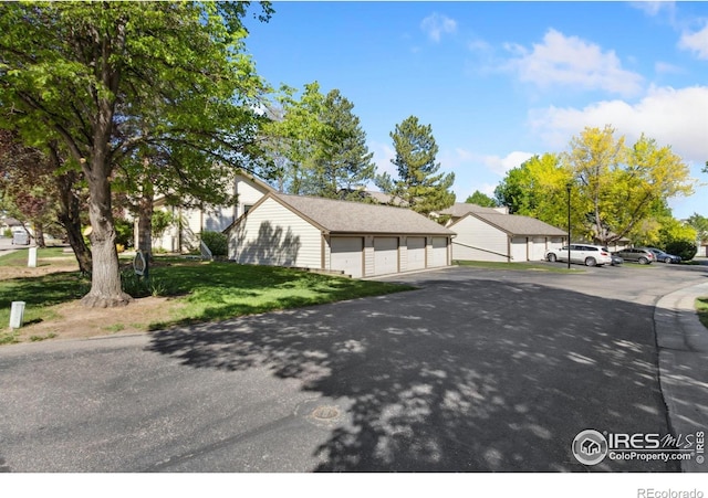 3465 Lochwood Dr Unit N62, Fort Collins, CO 80525 - view of side of home featuring a yard and community garages
