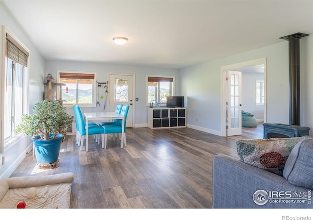 519 Palisade Mountain Dr, Drake, CO 80515 - dining room with wood finished floors, plenty of natural light, baseboards, and a wood stove