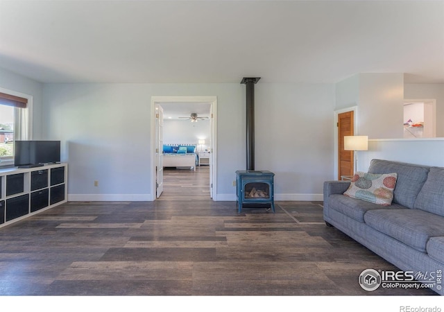 519 Palisade Mountain Dr, Drake, CO 80515 - living room featuring a wood stove, wood finished floors, and baseboards
