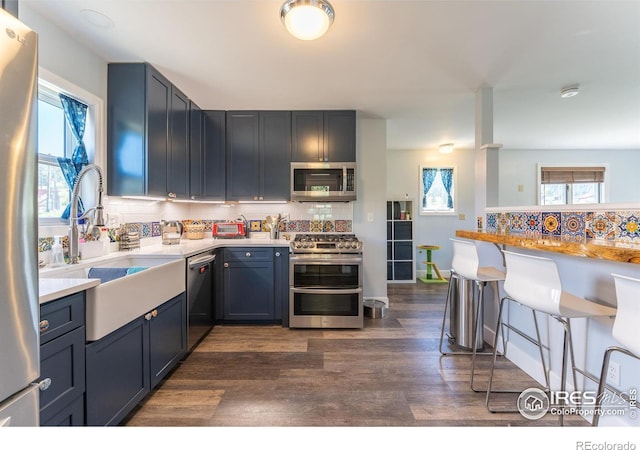 519 Palisade Mountain Dr, Drake, CO 80515 - kitchen featuring appliances with stainless steel finishes, a sink, backsplash, and dark wood finished floors