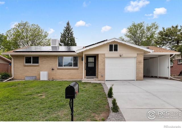 5329 Flower Cir, Arvada, CO 80002 - ranch-style house with driveway, brick siding, a front lawn, a garage, and solar panels