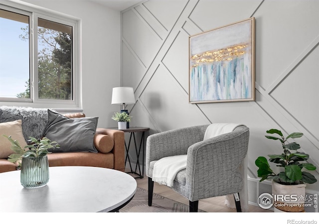 5329 Flower Cir, Arvada, CO 80002 - living room featuring a decorative wall and wood finished floors
