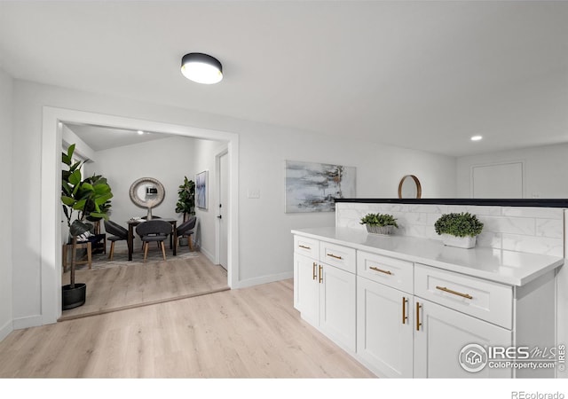 5329 Flower Cir, Arvada, CO 80002 - kitchen featuring light wood-style flooring, white cabinets, baseboards, light countertops, and recessed lighting