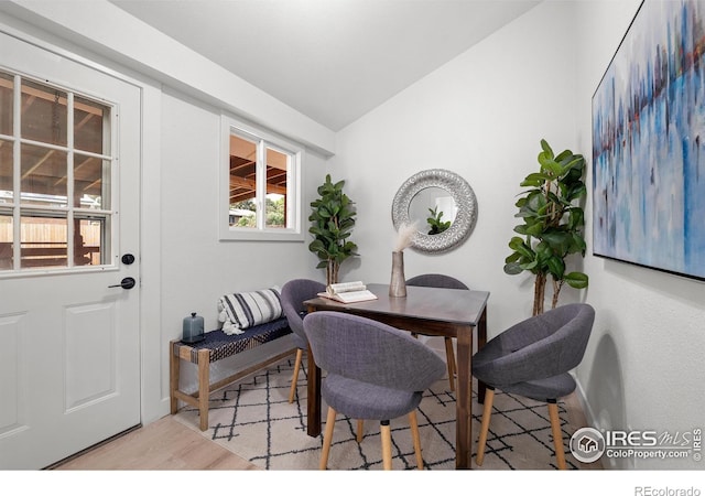 5329 Flower Cir, Arvada, CO 80002 - dining room with wood finished floors, vaulted ceiling, and healthy amount of natural light