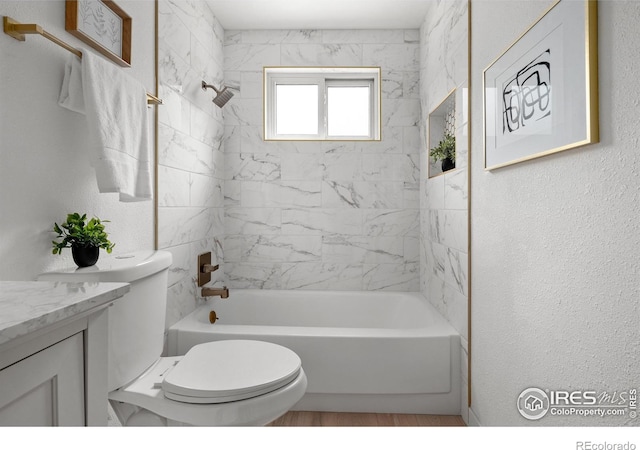 5329 Flower Cir, Arvada, CO 80002 - bathroom featuring toilet, vanity, bathing tub / shower combination, and a textured wall