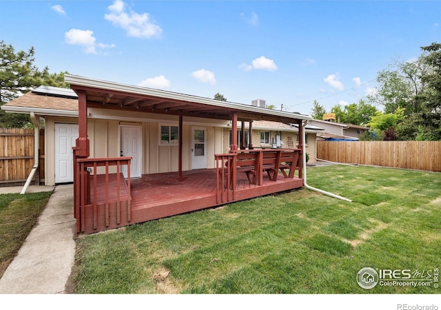 5329 Flower Cir, Arvada, CO 80002 - rear view of property with a deck, board and batten siding, and roof mounted solar panels