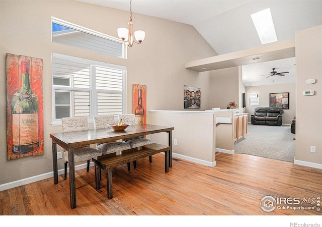 3525 Auntie Stone St Unit 7, Fort Collins, CO 80526 - dining space featuring a chandelier, plenty of natural light, a skylight, light wood-type flooring, and high vaulted ceiling