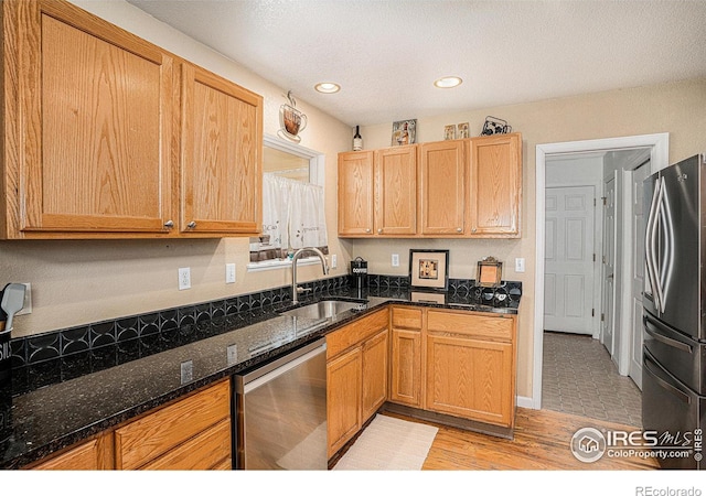 3525 Auntie Stone St Unit 7, Fort Collins, CO 80526 - kitchen featuring stainless steel appliances, a sink, dark stone countertops, recessed lighting, and light wood-type flooring
