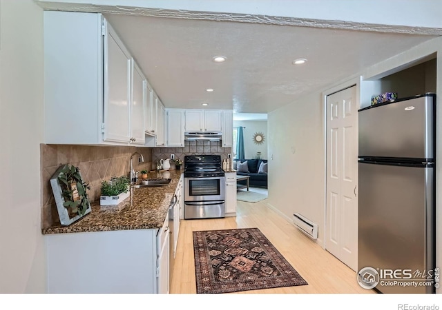 2977 Eagle Way, Boulder, CO 80301 - kitchen featuring appliances with stainless steel finishes, a sink, a baseboard heating unit, under cabinet range hood, and light wood-style floors