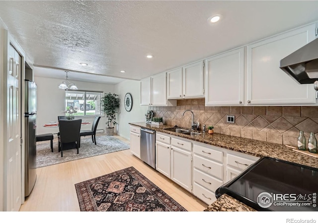 2977 Eagle Way, Boulder, CO 80301 - kitchen featuring appliances with stainless steel finishes, light wood-style floors, a sink, wall chimney range hood, and white cabinets