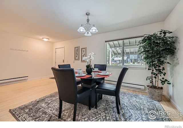 2977 Eagle Way, Boulder, CO 80301 - dining area featuring wood finished floors, a baseboard radiator, and a chandelier