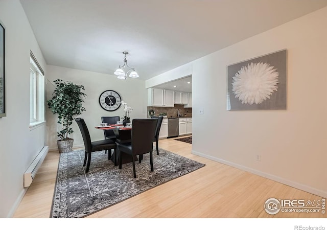 2977 Eagle Way, Boulder, CO 80301 - dining space featuring a baseboard heating unit, light wood-type flooring, a chandelier, and baseboards
